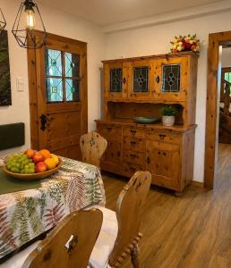 a kitchen with a table with a bowl of fruit on it at Skoff Original Holzhaus in Eckberg