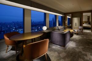 a living room with a couch and a table at Keio Plaza Hotel Tokyo in Tokyo