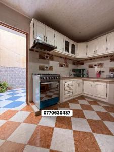 a large kitchen with white cabinets and an oven at حي السلام سيدالمجدوب in Sidi Mohammed Medjoub +12 photos