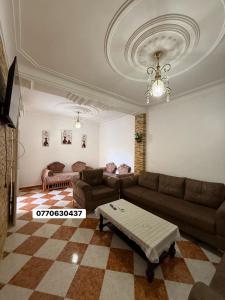 a living room with a couch and a table at حي السلام سيدالمجدوب in Sidi Mohammed Medjoub