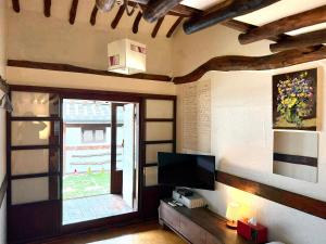 a living room with a television and a window at Gohyundang in Jeonju