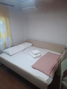 a bed in a room with two towels on it at LavenderFarmhouse 2 in Nafpaktos