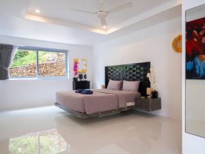 a bedroom with a bed and a large window at Cosi Flat & Pool - Chaweng Area in Chaweng +18 photos