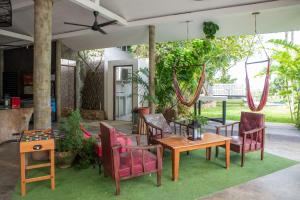 a patio with chairs and a table and a table at Cosi Flat & Pool - Chaweng Area in Chaweng