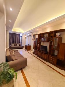 a large living room with a couch and a television at suites in cairo downtown in Cairo