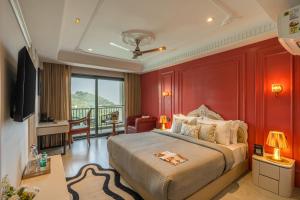 a bedroom with a large bed with red walls at Perfectstayz Prime - 2 min walk to mall road in Mussoorie