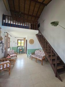 a living room with a staircase and couches at Five Fingers Holiday Bungalows in Kyrenia