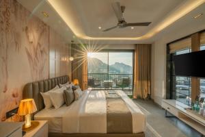 a bedroom with a large bed with a large window at Perfectstayz Prime - 2 min walk to mall road in Mussoorie
