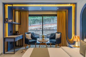 a room with a desk and two chairs and a window at Perfectstayz Prime - 2 min walk to mall road in Mussoorie +150 photos