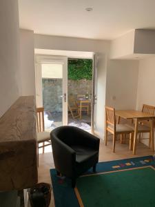 a bedroom with a chair and a table and a dining room at Greenkeepers Rest in Longniddry
