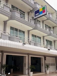 a large building with a sign on top of it at THE BEACH INN Cha-Am in Cha Am