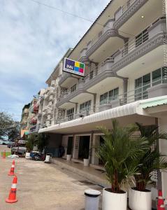 a large building with orange cones in front of it at THE BEACH INN Cha-Am in Cha Am +24 photos