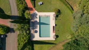 an overhead view of a swimming pool on a lawn at Podere Fignano, holiday home - apartments renovated 2024 - new swimming pool in Montaione