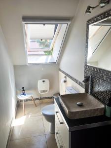 a bathroom with a sink and a toilet and a window at Biały Dom in Kąty Rybackie +26 photos