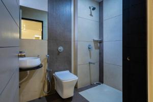 ein Badezimmer mit Toilette und Waschbecken in der Unterkunft Hotel Gold Star in Rajkot + 26 Fotos