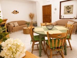 a living room with a green table and chairs at Eva's House in Amarynthos