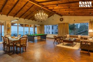 a living room with a ping pong table at StayVista at The Cloudberry Crest with BBQ & Bonfire in Rāmgarh