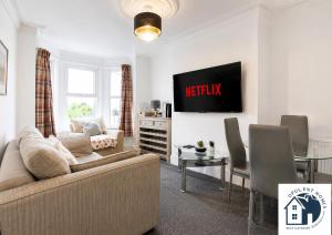 a living room with a couch and a table at Contactor Stay, Reading Town Centre 4 Bed House, Large House with 2 bath in Reading