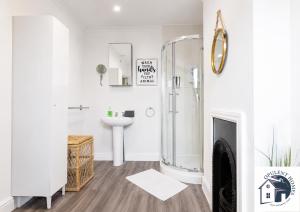 a white bathroom with a shower and a sink at Contactor Stay, Reading Town Centre 4 Bed House, Large House with 2 bath in Reading +41 photos