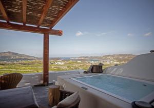 a hot tub with a view of the ocean at Ktima Lipsi, Panorama Pool Views in Klouvas