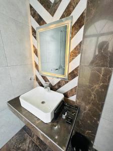 a bathroom with a sink and a mirror at Go 001 Hotel Lahore in Lahore