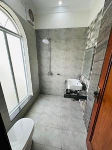 a bathroom with a shower and a toilet and a sink at Go 001 Hotel Lahore in Lahore