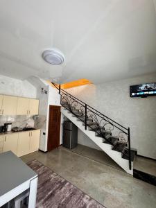 a room with a staircase with a tv on the wall at Family House in Sevan +10 photos