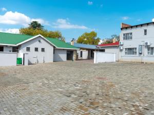 an empty parking lot in front of buildings at Lasaro Guest Lodge in Bethlehem