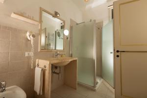 a bathroom with a sink and a shower with a mirror at Casale del Murgese Country Resort in Savelletri di Fasano +41 photos