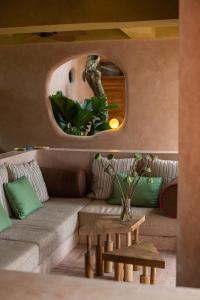 a living room with a couch and a round mirror at Moon Gang Ubud in Ubud