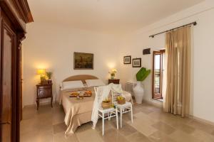 a bedroom with a bed and a table with food on it at Casale del Murgese Country Resort in Savelletri di Fasano
