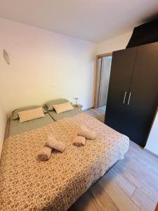 a bedroom with a bed with two slippers on it at Studio Babji zob in Bohinjska Bela