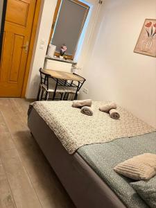 a bedroom with a bed and a table and a window at Studio Babji zob in Bohinjska Bela