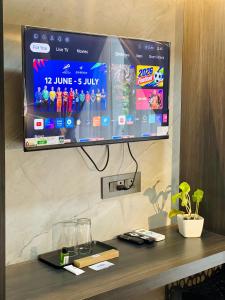 a flat screen tv hanging on a wall at Aleida Residency in Cochin