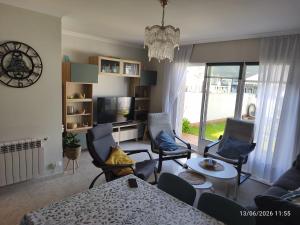 a living room with a table and chairs at ADOSADO Avda BREOGAN 71 in Foz