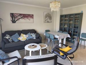 a living room with a couch and a table at ADOSADO Avda BREOGAN 71 in Foz