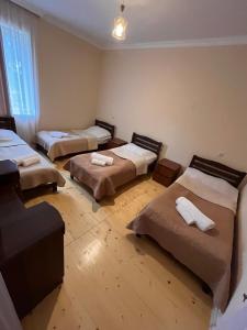 a room with three beds in a room at Qedani in Ch'k'valeri +10 photos