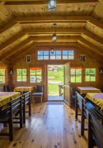a dining room with tables and chairs in a building at Maple bungalows in Žabljak