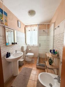 a bathroom with a sink and a toilet and a shower at La casa di Sally in Syracuse