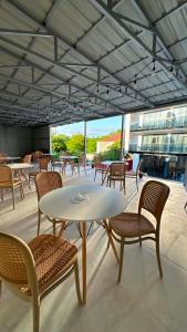 a white table and chairs on a patio at Hotel Nena in Kobuleti
