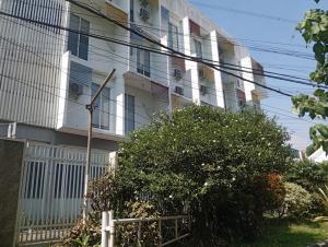 a white building with a lot of windows at Townhouse Oak Hotel Damar Kurung in Gresik