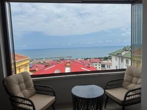 a room with two chairs and a large window at Yasmine Suit in Trabzon