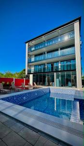 a building with a swimming pool in front of a building at Hotel Nena in Kobuleti