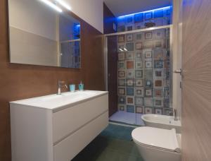 a bathroom with a sink and a toilet and a shower at Casa Alexandr Azzurra in Pizzo