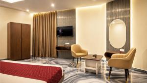 a hotel room with a bed and a mirror at Jowar Hotel & Resort in Digha