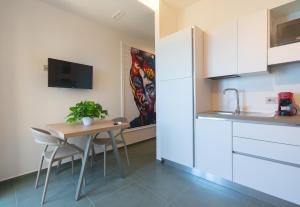 a kitchen with a table and chairs and a tv at Casa Alexandr Azzurra in Pizzo