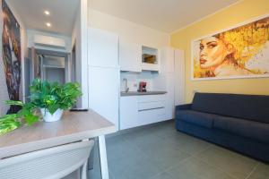 a living room with a blue couch and a table at Casa Alexandr Azzurra in Pizzo +8 photos