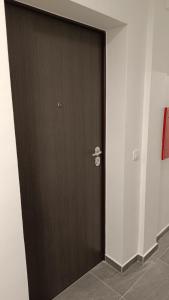 a wooden door in a room with at Apartman Rena in Ivanec