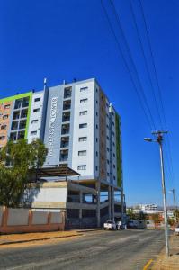 a large white building on the side of a street at Jambi Merensky Nest in Windhoek