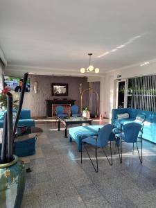 a living room with blue furniture and a swimming pool at Paraiso Termal in Federación
